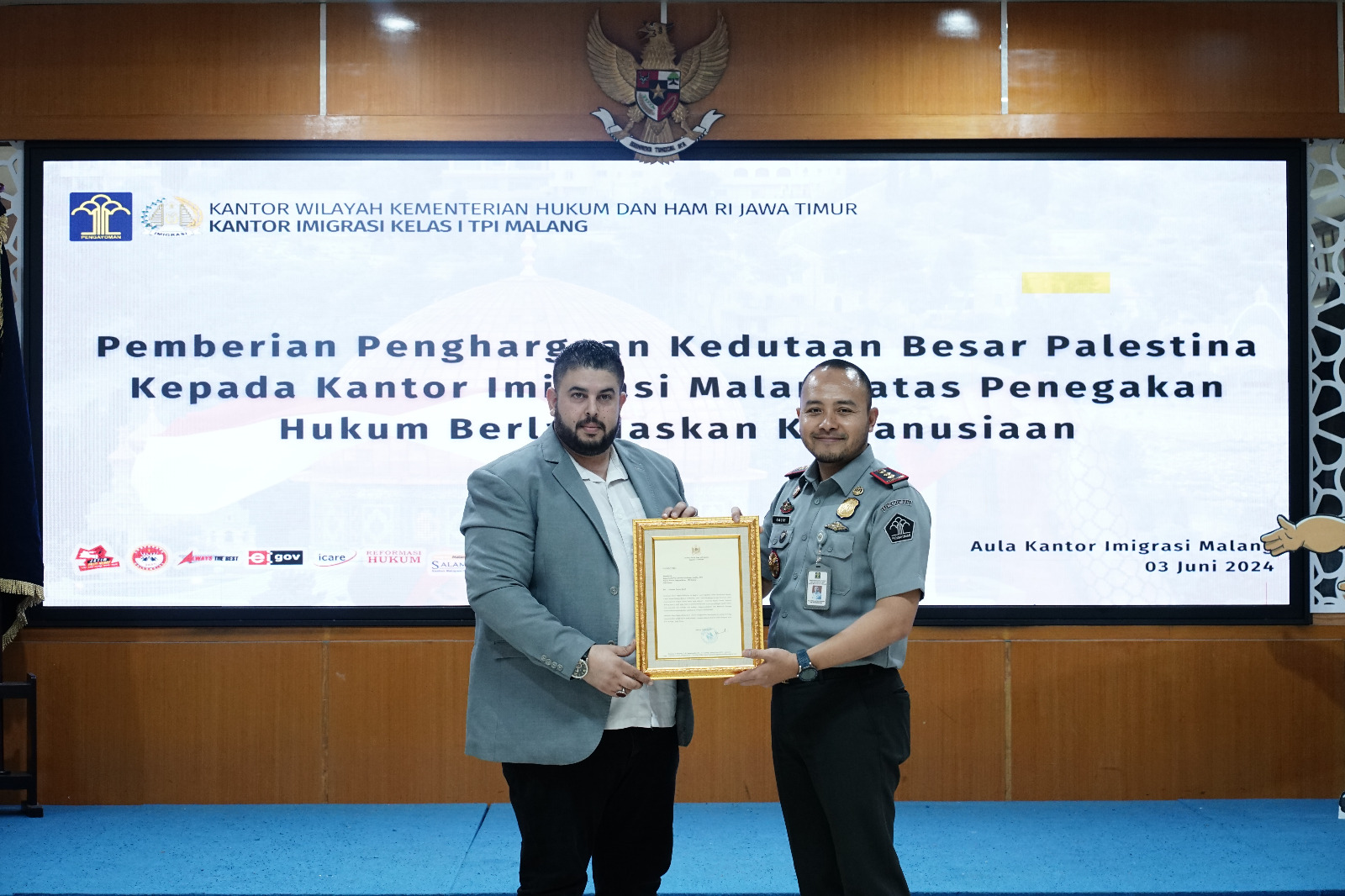 Fathi M Ghazal, perwakilan Kedubes Palestina menyerahkan penghargaan untuk Kepala Imigrasi Malang Galih Priya Kartika Perdhana