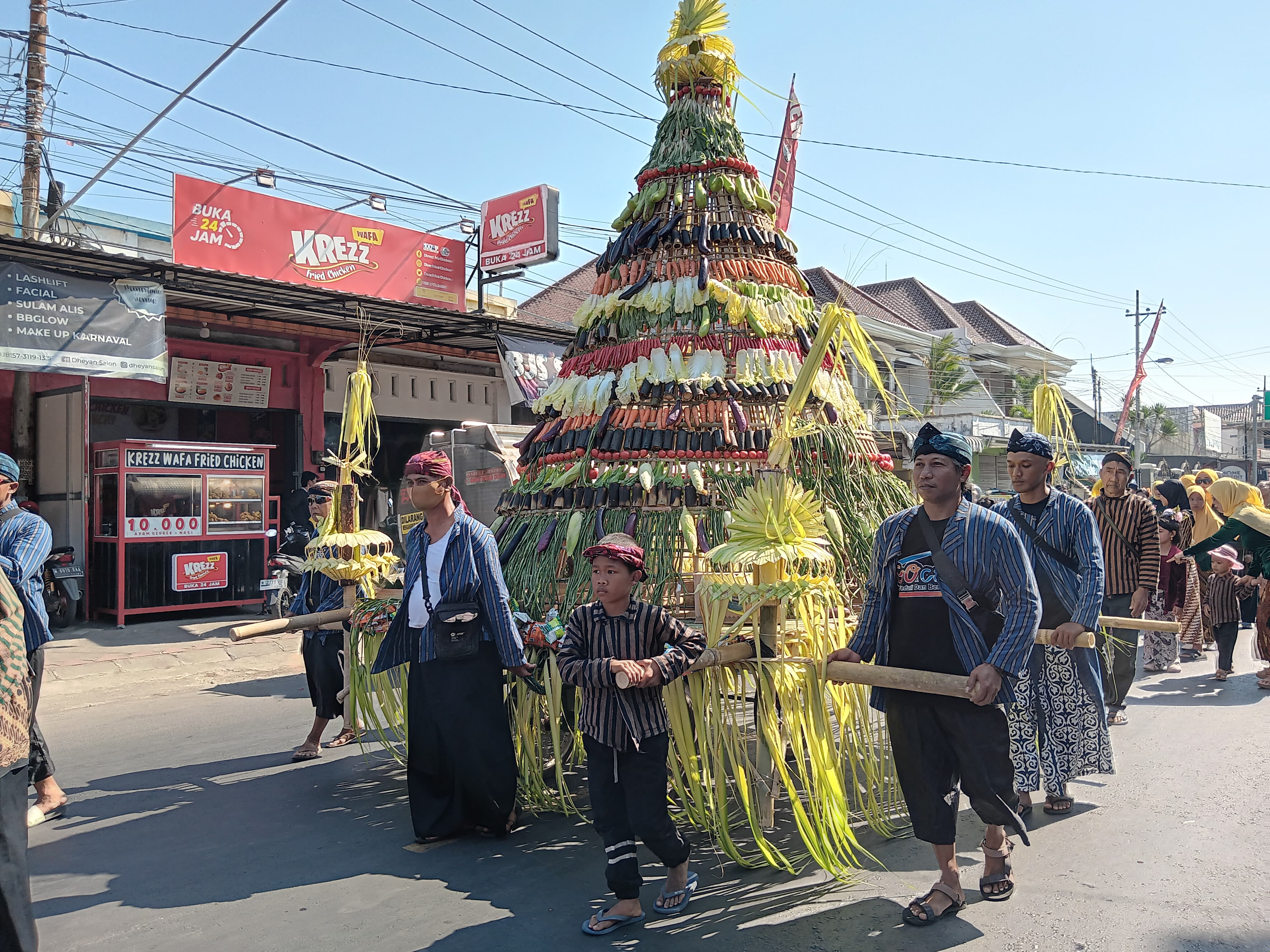 TRADISI: Ratusan warga Gondanglegi mengarak tumpeng, gunungan sayur, dan jajanan dari kantor Kecamatan Gondanglegi menuju makam Mbah Sogol kemarin (17/7).