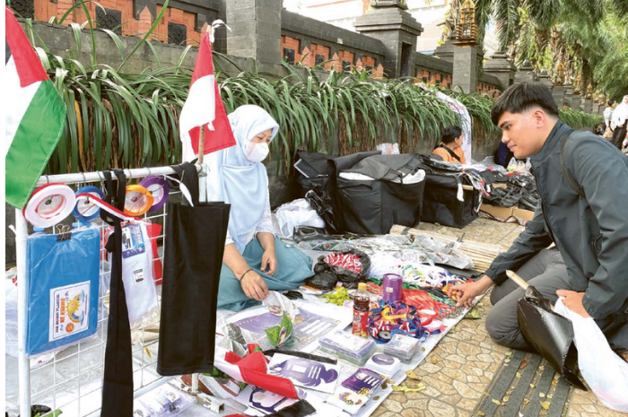 MUSIMAN: Salah satu pedagang pernak-pernik ospek membuka lapak di trotoar Jalan Veteran, Kecamatan Klojen, kemarin siang.
