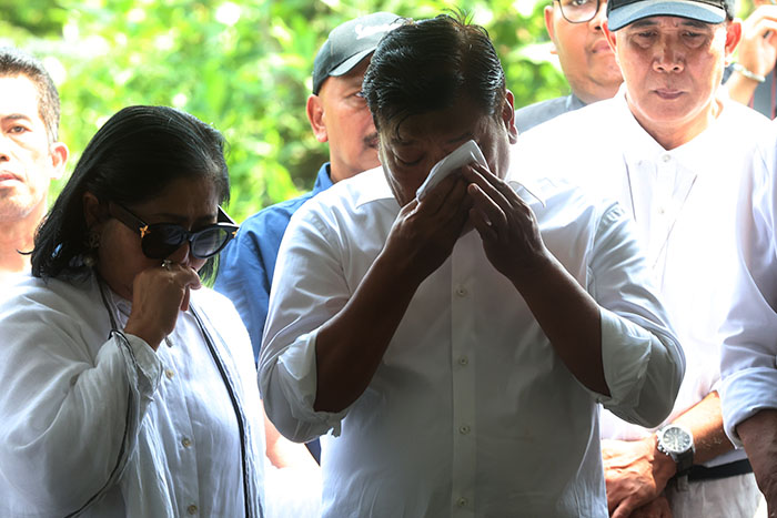 Andreas Eddy Susetyo, anggota DPR RI sekaligus saudara kandung mendiang Romo Benny (kanan) menyeka air matanya di depan pusara