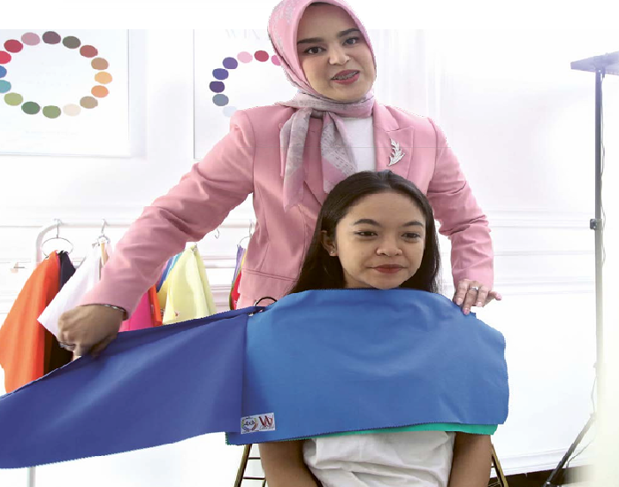 JADI INVESTASI: Sartika Sari melayani salah satu kliennya, Jumat lalu (29/11). Dia membuka layanan personal color analysis sejak 2023 lalu. SATRIA CAHYONO/RADAR MALANG