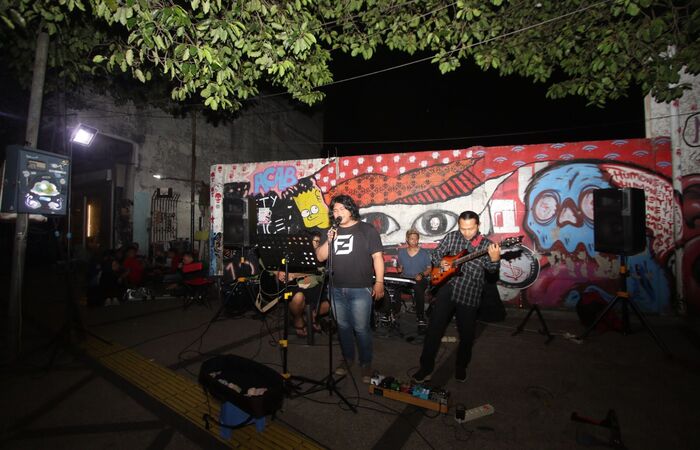 MENGHIBUR WISATAWAN: Salah satu grup musik lokal tampil di jalur pedestrian Kajoetangan Heritage kemarin malam (23/12).