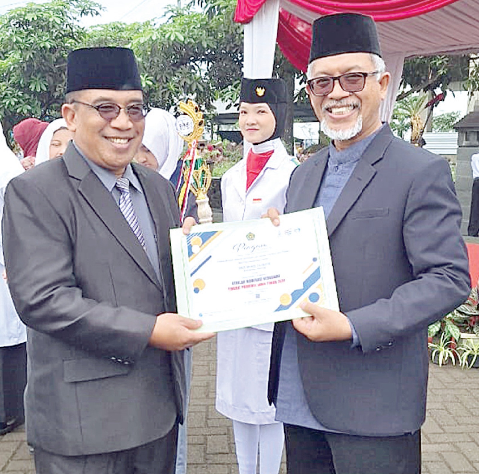BANGGA: Kepala SMANELA Dr Abdul Tedy MPd (kanan) menerima penghargaan Juara 1 SMB kategori SMA se-Jatim oleh Kepala Kemenag Kabupaten Malang Drs Sahid MM.