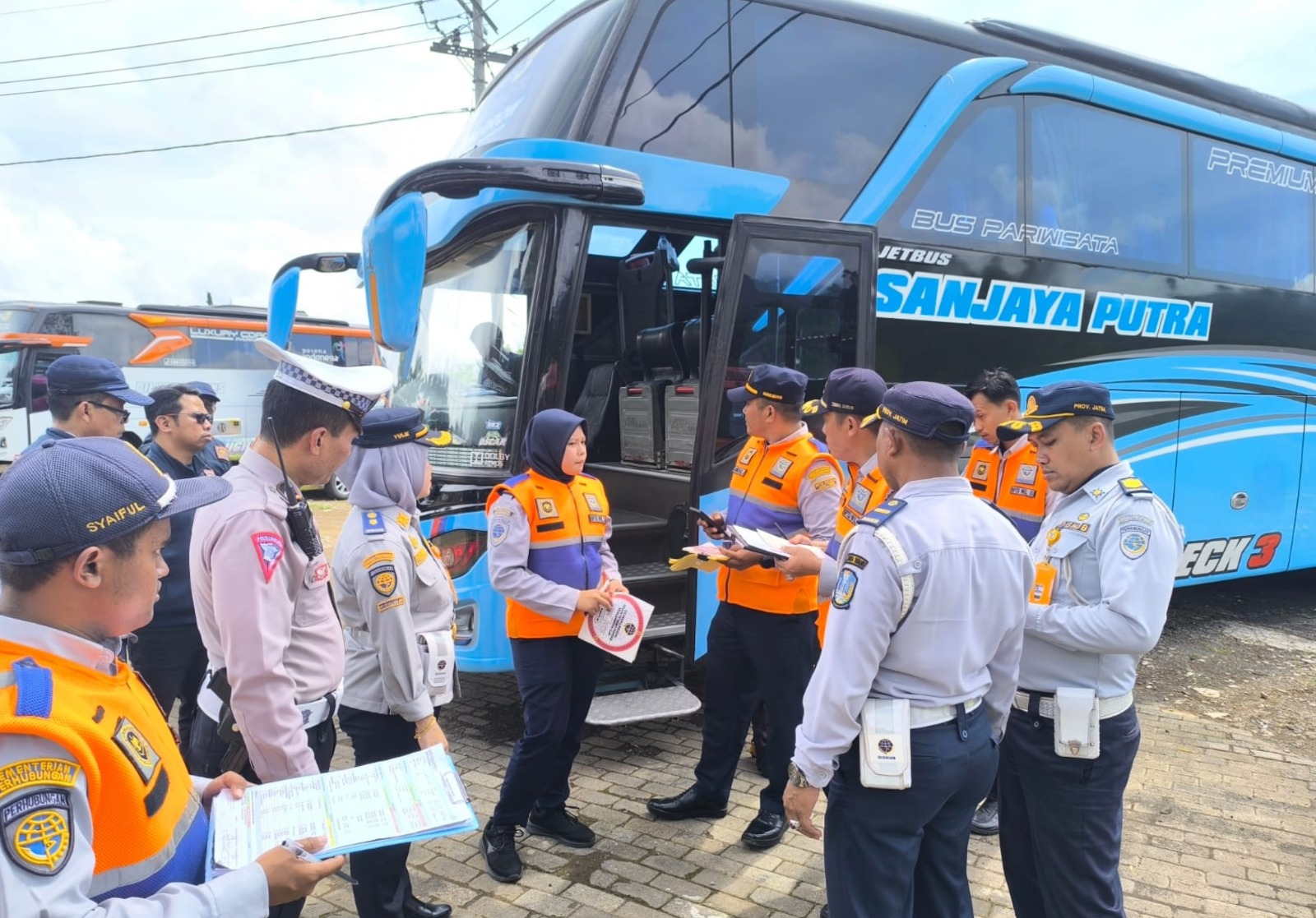 RUTIN: Petugas gabungan memeriksa dokumen administrasi dan kondisi fisik bus pariwisata di tempat parkir Selecta pada Minggu lalu (19/1). DISHUB KOTA BATU FOR RADAR MALANG