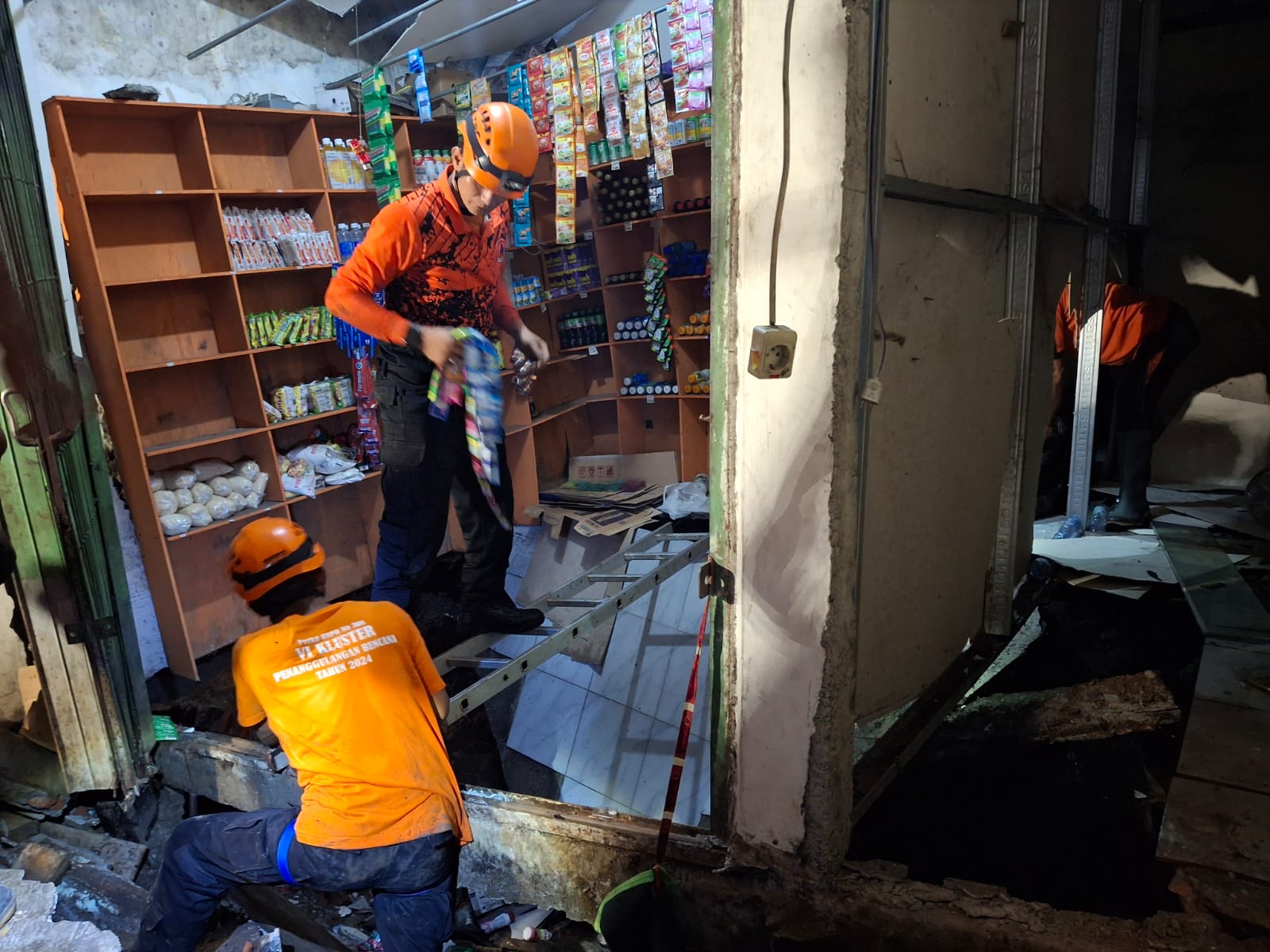 BPBD Kota Malang melakukan evakuasi di warung yang ambrol pada Rabu (19/2) sore. (Nabila Amelia/Radar Malang)