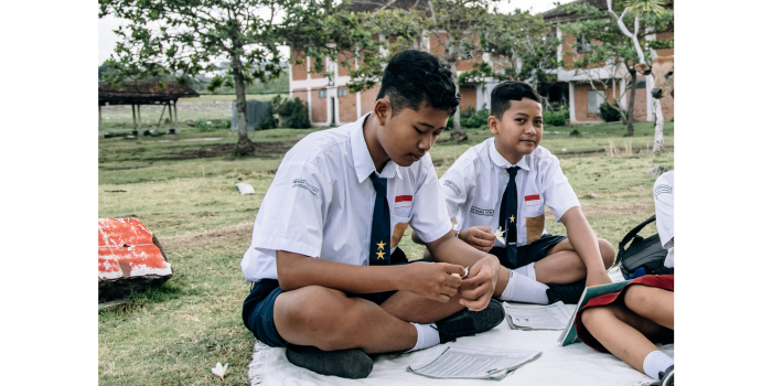 Ilustrasi siswa SMP sedang duduk di lapangan. (Pexels: ROMAN ODINTSOV)