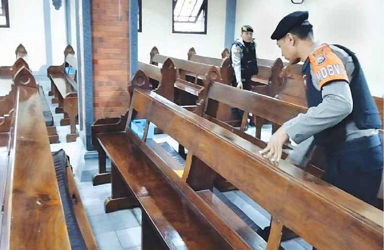 PENGAMANAN: Beberapa personel dari Polres Malang menyisir beberapa area menggunakan metal detector di Gereja Katolik Paroki Santa Maria Tak Bernoda, Kelurahan Lawang, Kecamatan Lawang kemarin (18/4).