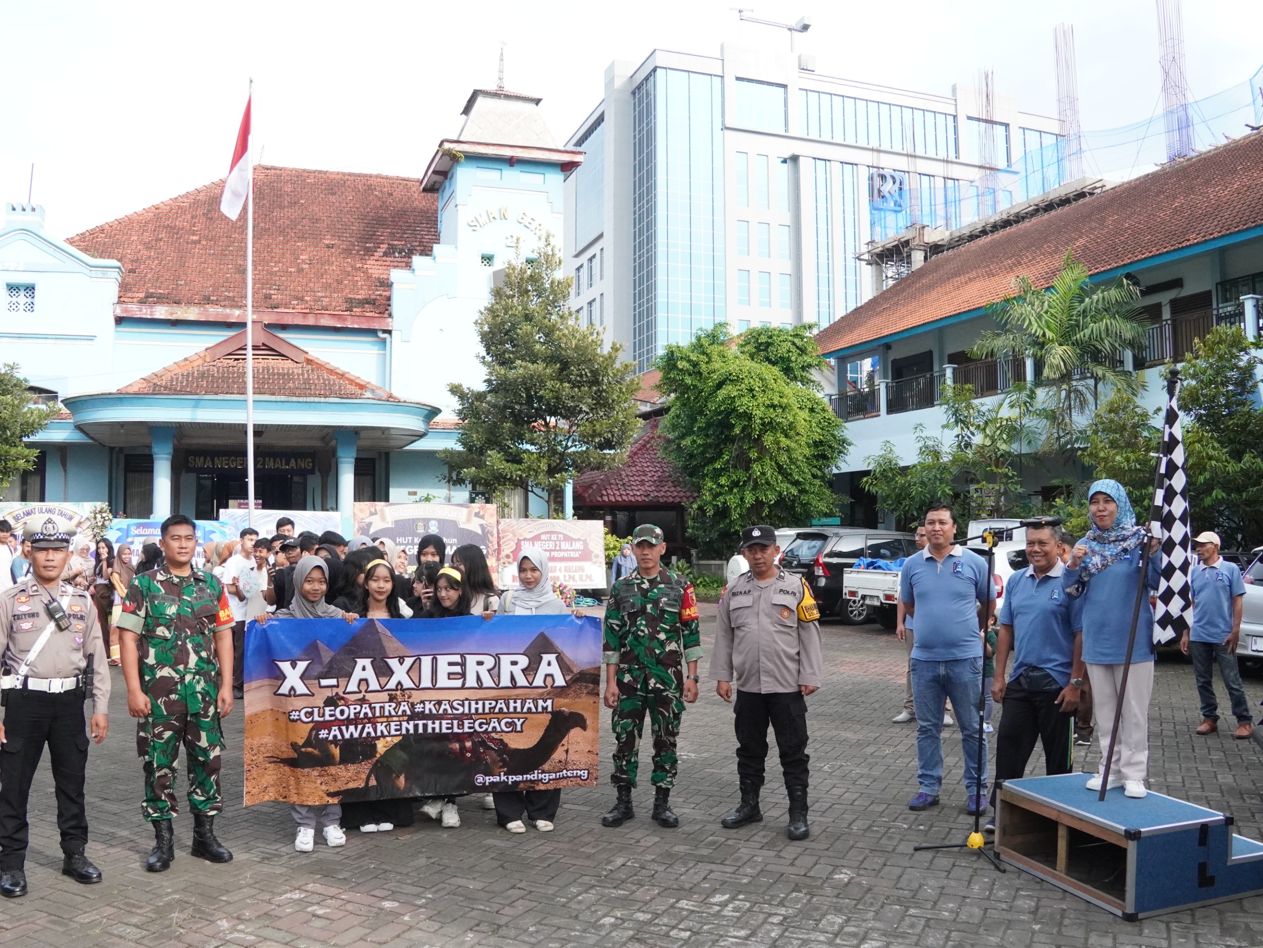 SEHAT JASMANI : Kepala Sekolah Dra Fety Susilawatie MPd (kanan) saat pemberangkatan peserta Fun Walk dalam rangkaian acara HUT SMAN 2 Malang, Kamis (17/4).