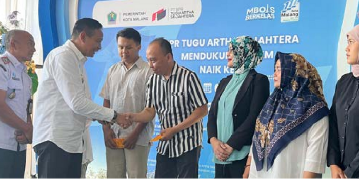 BANTU PERMODALAN: Wali Kota Malang Wahyu Hidayat menyampaikan  bantuan tabungan gratis ke sejumlah pelaku UMKM di Kantor BPR Tugu Artha, kemarin.