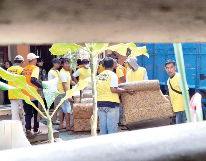 MILIK PENGUSAHA: Perabotan dari rumah di Jalan Bandung Nomor 34, Kelurahan Penanggungan, Kota Malang dikeluarkan petugas sebelum disita, kemarin (22/5). Eksekusi sebelumnya sempat batal karena ada pen