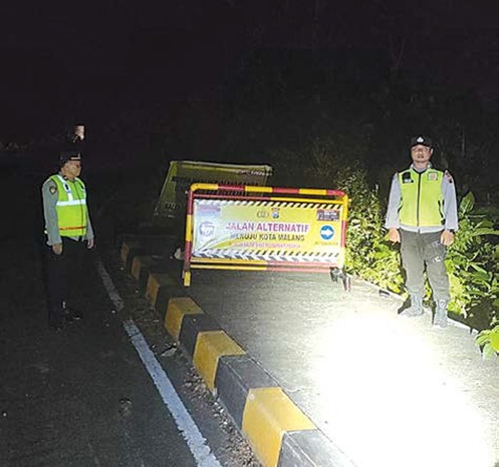 SIAGA: Anggota dari jajaran Polsek di Kabupaten Malang bersiap mengarahkan wisatawan yang hendak menuju Pantai Balekambang. Tujuannya agar melintasi jalur alternative sehingga tidak terjebak macet.