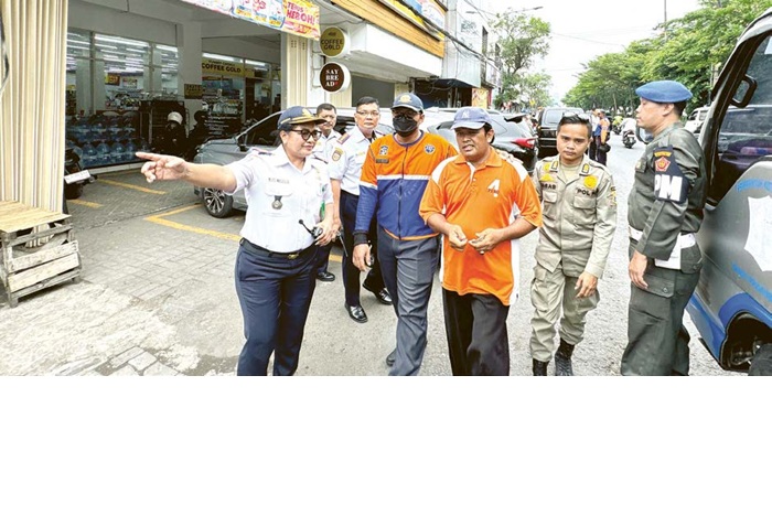 TEGAS: Petugas Dishub Surabaya mengamankan jukir liar. Pemkot meminta pemilik usaha untuk menyediakan jukir resmi.