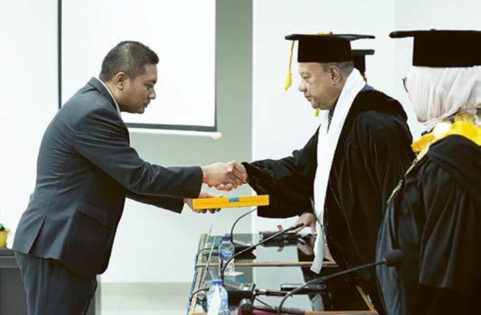 UCAPAN SELAMAT: Dr drh H Puguh Wiji Pamungkas MM berjabat tangan dengan Prof Dr Bonaventura Ngarawula MS bertindak sebagai promotor.
