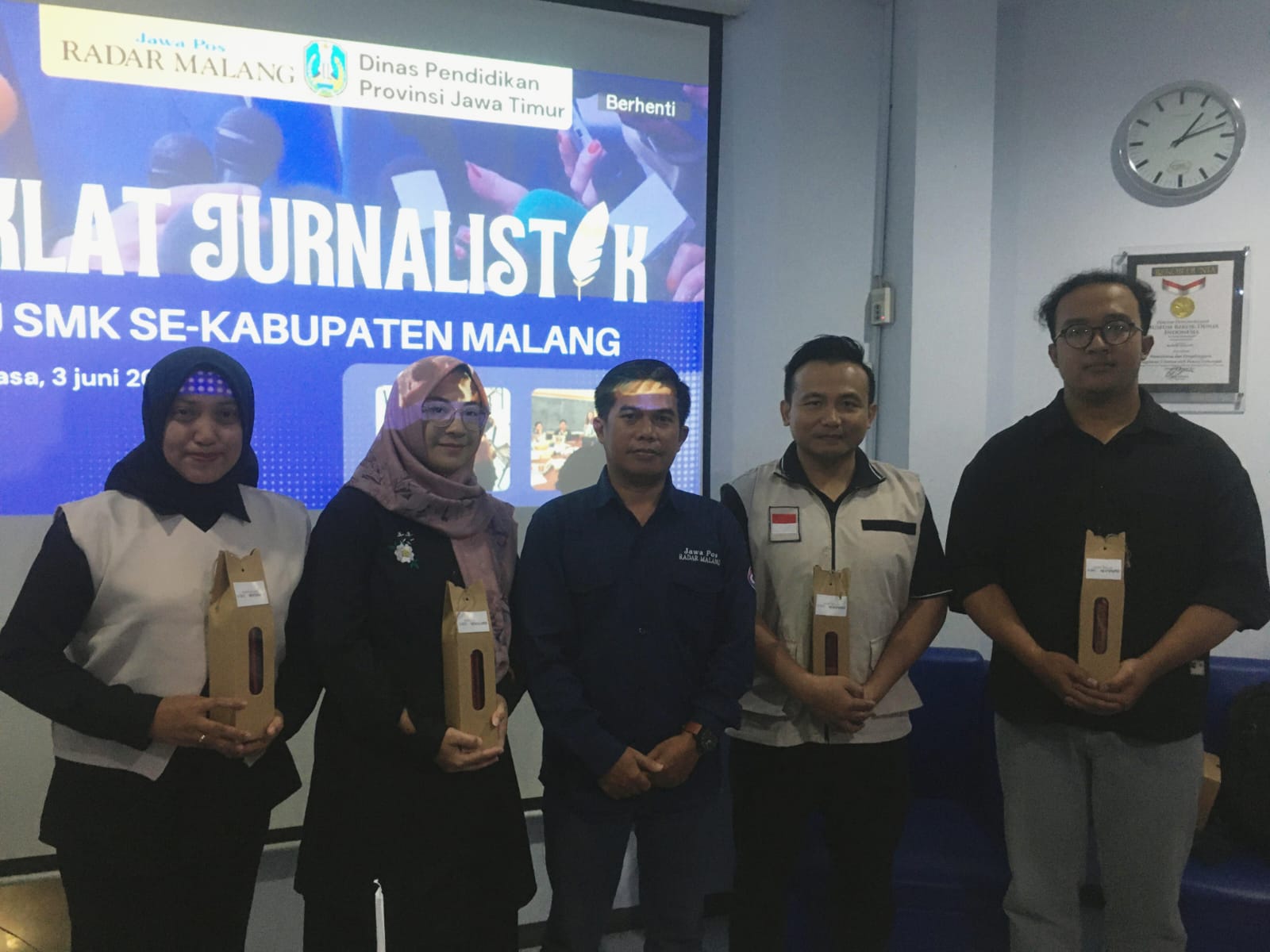 PERKUAT LITERASI : Redaktur Senior Jawa Pos Radar Malang Mahmudan (tengah) menyerahkan hadiah exclusive kepada peserta Diklat Jurnalistik Guru SMK se-Kabupaten Malang, Selasa (3/6).