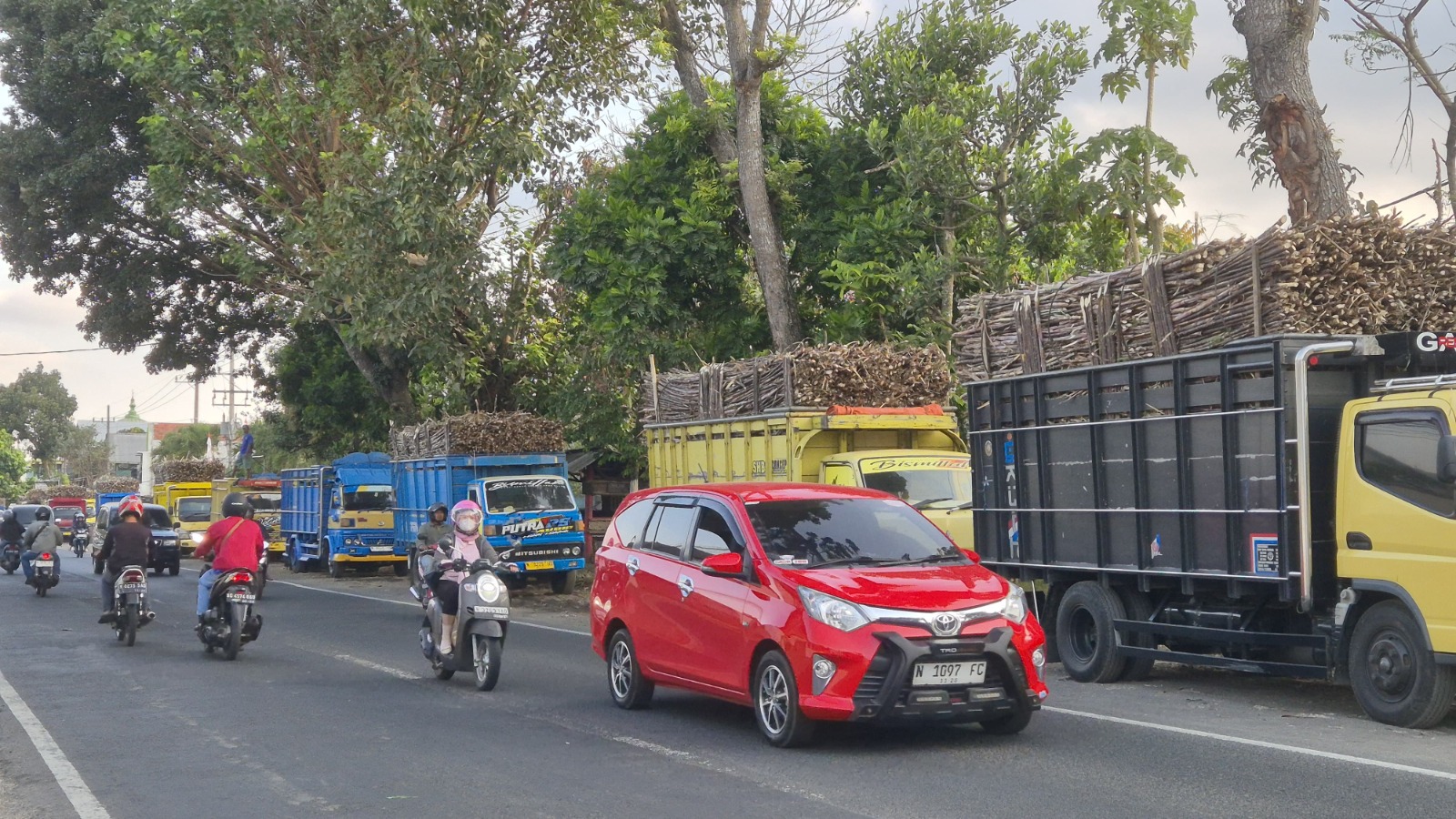 GANGGU KEINDAHAN: Deretan truk bermuatan tebu parkir di tepi ruas Jalan Raya Kendalpayak, Kecamatan Pakisaji kemarin.