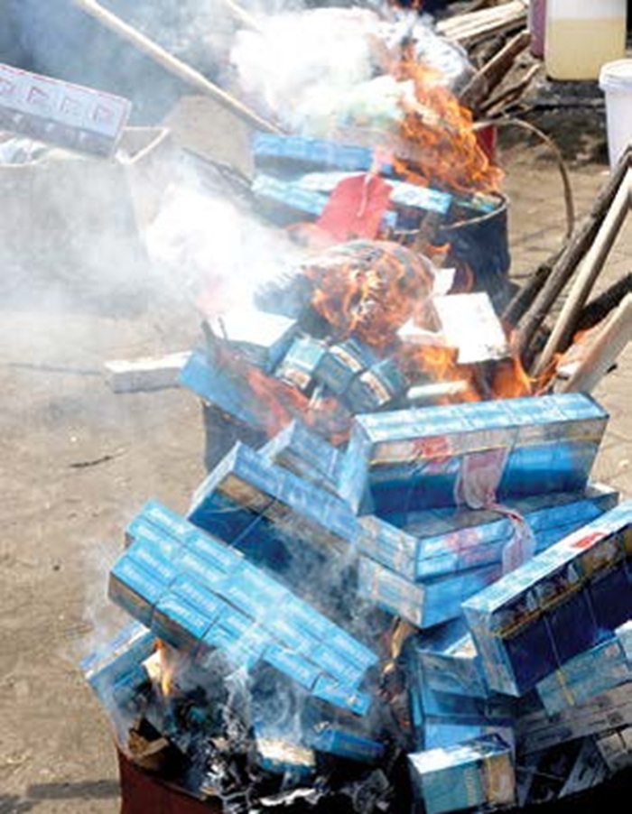 DIBAKAR HABIS: Sejumlah rokok ilegal dimusnahkan dengan cara dibakar di kantor Kejaksaan Negeri (Kejari) Kota Malang, kemarin (7/8).