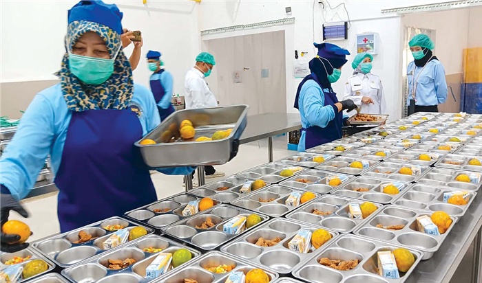 HIGIENIS: Pegawai di SPPG Karangploso menunjukkan menu Makan Bergizi Gratis (MBG) yang siap didistribusikan kemarin (13/8).