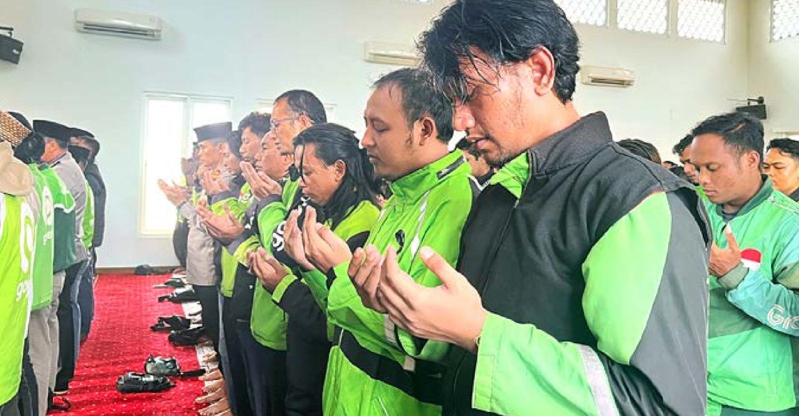 UNTUK ALMARHUM: Salah satu driver ojol mengikuti salat gaib di Polresta Malang Kota, kemarin siang. Kapolresta Malang Kota Kombes Pol Nanang Haryono ikut ambil bagia