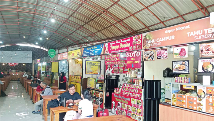 SENTRA KULINER: Pengunjung menikmati makanan di pujasera Kantor Pos Malang kemarin. Tahun depan Pemkot Malang kehilangan Rp 8 miliar dari dua pajak.
