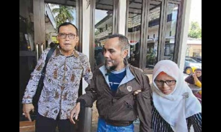 TUNTUT KEADILAN: Yulianto (tengah) didampingi istri dan kuasa hukumnya melapor ke Mapolres Malang kemarin (26/9).