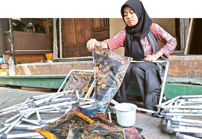 KREATIF: Seorang pegawai Soendari Batik Art and Gallery Malang menunjukkan cara membuat batik kemarin (2/10).