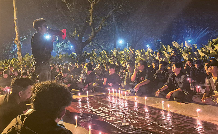SAMPAIKAN ASPIRASI: Mahasiswa yang tergabung dalam BEM Malang Raya melakukan aksi simbolik di depan Monumen Tragedi Kanjuruhan, Rabu malam (1/10).