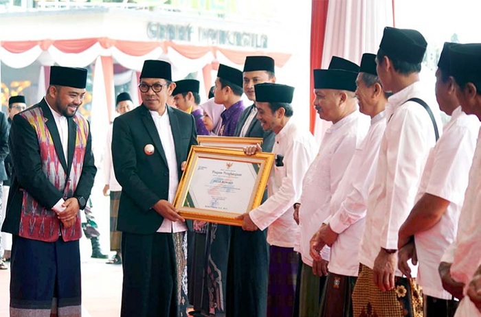 SIMBOLIS: Wali Kota Batu Nurochman (dua dari kiri) menyerahkan piagam izin operasional pesantren setelah upacara peringatan Hari Santri Nasional (HSN) di balai kota kemarin (22/10).