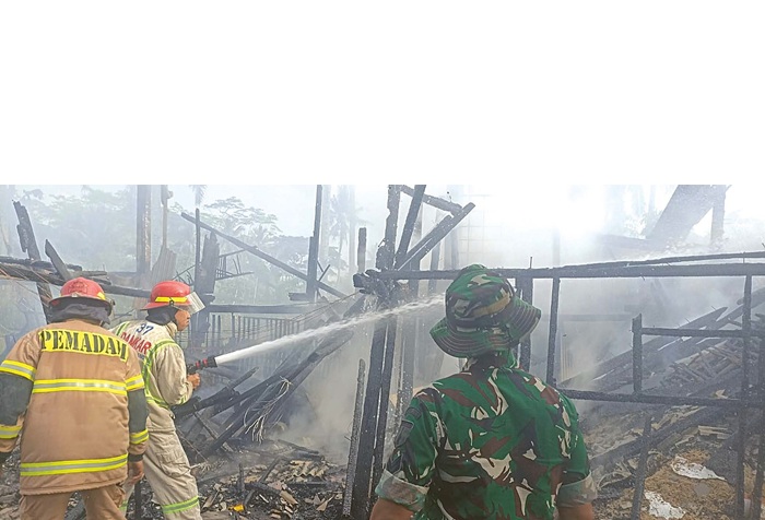 KORSLETING: Petugas Damkar Kabupaten Malang berupaya memadamkan sisa-sisa api di sebuah kandang ayam di Kelurahan Cepokomulyo, Kecamatan Kepanjen, kemarin pagi (23/10).