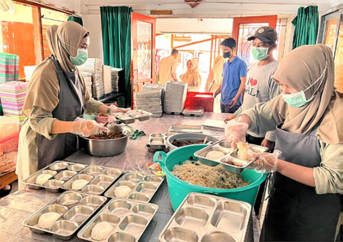 JAGA KUALITAS: Juru masak di dapur SD-SMP Insan Amanah menyiapkan menu makan siang untuk para siswa kemarin