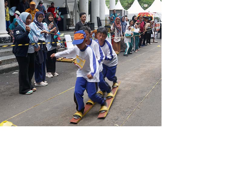 TRADISIONAL: Siswa-siswi SD adu kecepatan dan kekompakan bermain bakiak di doom Universitas Muhammadiyah Malang (UMM) kemarin.