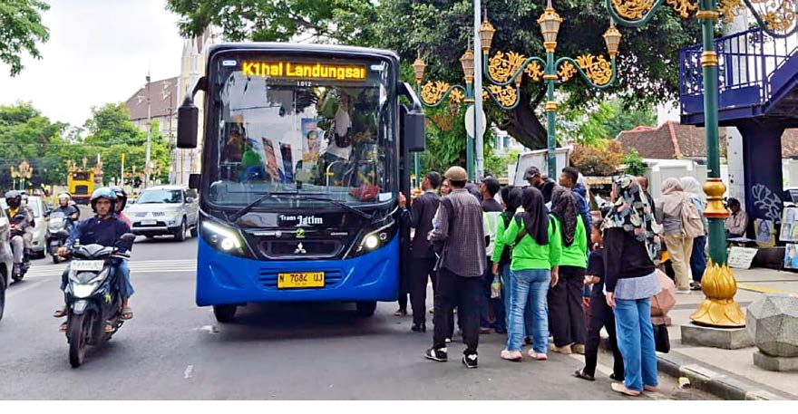 ANIMO TINGGI: Sejumlah penumpang mengantre masuk ke bus Trans Jatim yang melintas di koridor Kajoetangan, kemarin siang.