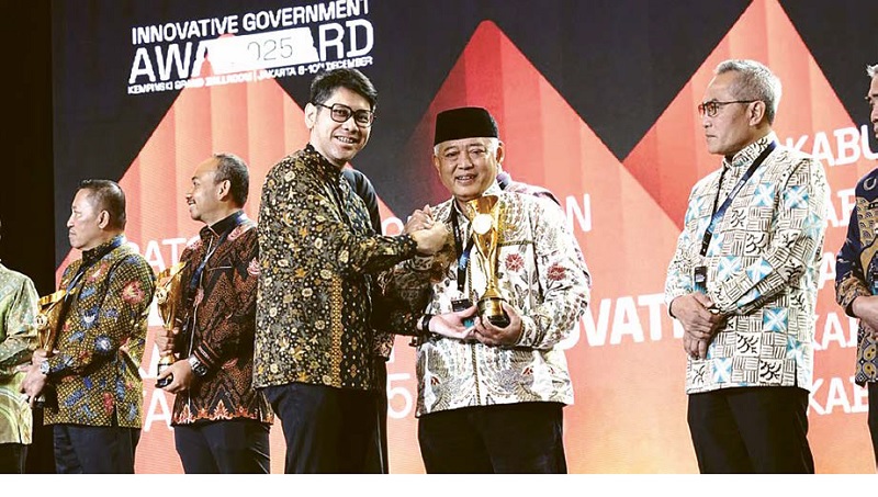 LEWATI EMPAT TAHAP: Bupati Malang H M. Sanusi menerima penghargaan Innovative Government Award 2025 yang disampaikan Wakil Rektor UI Bidang Perencanaan, Keuangan, dan Sumber Daya Ahmad Gamal SArs MSi