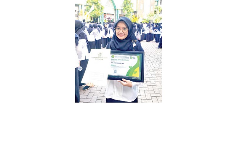 DAPAT REWARD: Kepala MTs Hasyim Asy&rsquo;ari Surotus Tsaniyah menerima piagam penghargaan Lomba ASRI yang diadakan Kemenag Kota Malang.