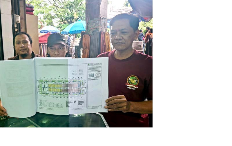 ASPIRASI: Pedagang Pasar Besar Malang membeber draf AMDAL Pasar Besar Malang kemarin (7/1). Mereka menolak karena ukuran lapak pedagang mengecil.
