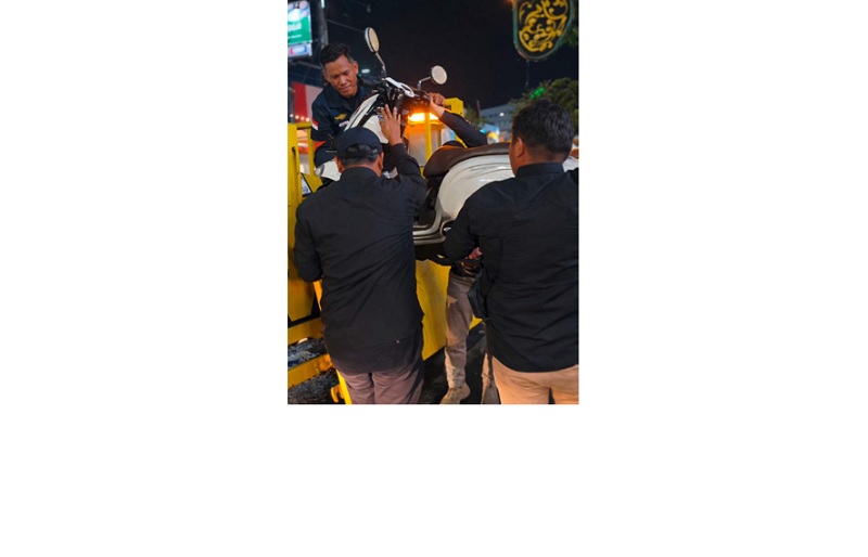 MELANGGAR: Petugas Dishub Kota Malang mengangkut sepeda motor yang parkir sembarangan di kawasan Kajoetangan pada Sabtu (10/1) malam.