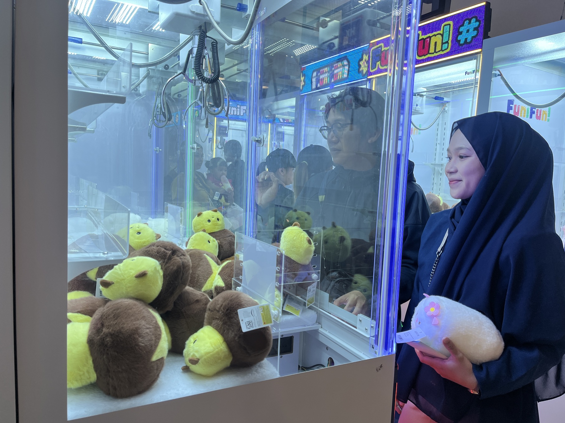 TERGANTUNG HOKI: Mesin capit boneka di MOG mampu menyedot animo pengunjung untuk bermain. (Nahdiatul Affandiah/Radar Malang)