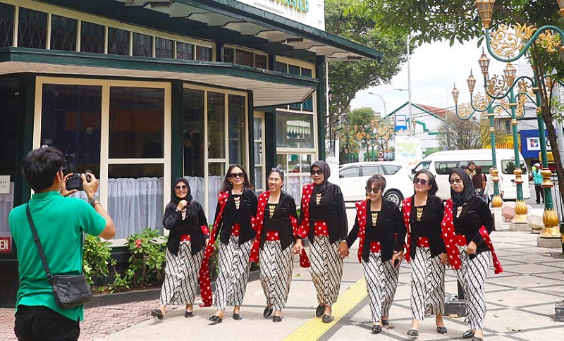 KOMPAK: Para wisatawan Kajoetangan Heritage berpose menggunakan busana tempo doeloe di trotoar Jalan Basuki Rahmat kemarin (18/1).
