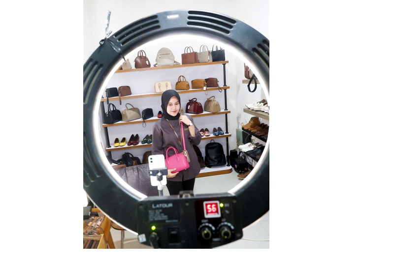 DAPAT TARGET KHUSUS: Salah satu crew Shoeka Shoes, produsen sepatu dan tas kulit dari Sawojajar melakukan live streaming untuk memasarkan produknya, kemarin (26/1). Pemkot Malang memberi target khusus