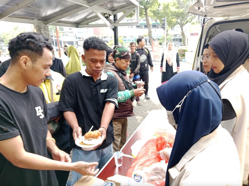 SELALU RAMAI: Pengemudi ojek online antre mengambil makanan yang disajikan Warung Azzahra secara gratis kemarin.