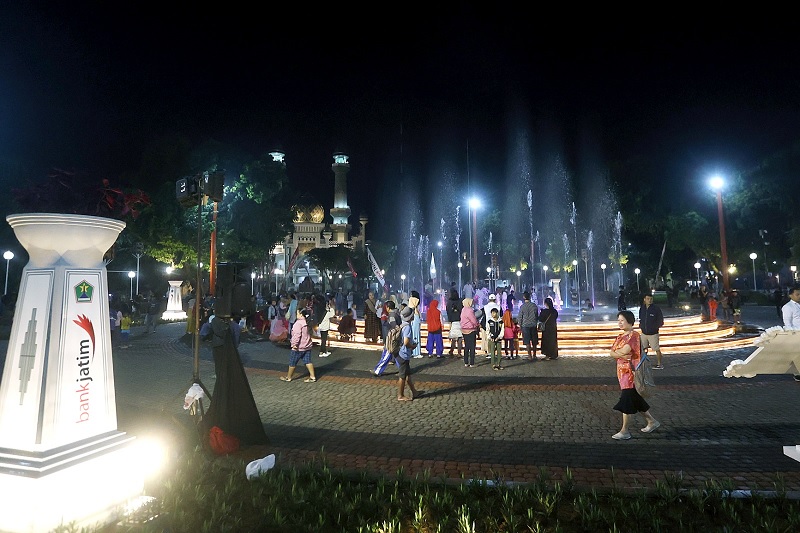 RAWAN SEMRAWUT: Warga memadati area air mancur di Alun-Alun Merdeka setelah dilakukan launching pada Rabu malam (28/1). Foto kiri, Wali Kota Malang Wahyu Hidayat (kanan) menyaksikan anak-anak yang