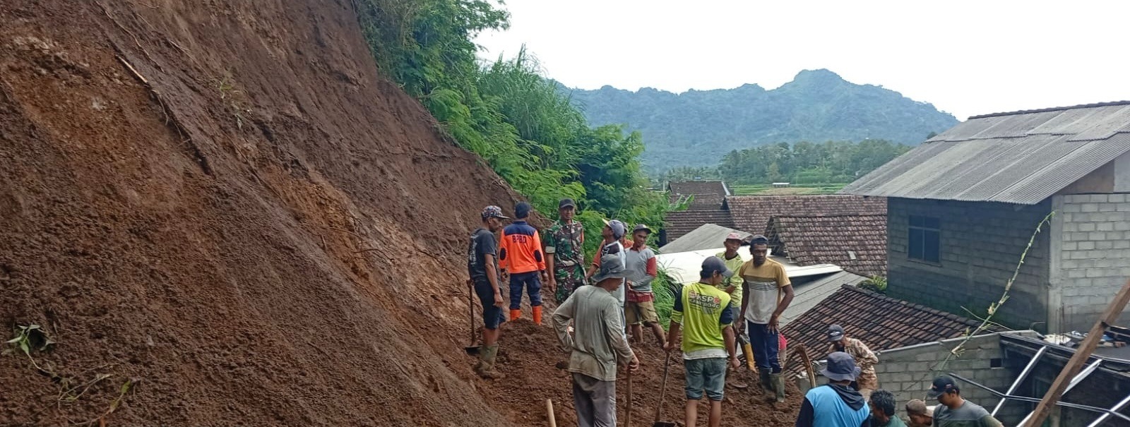 NIHIL KORBAN: Warga bersama aparat gotong royong membersihkan sisa-sisa material longsoran di Dusun Sayang, Desa Tulungrejo, Kecamatan Ngantang, kemarin.