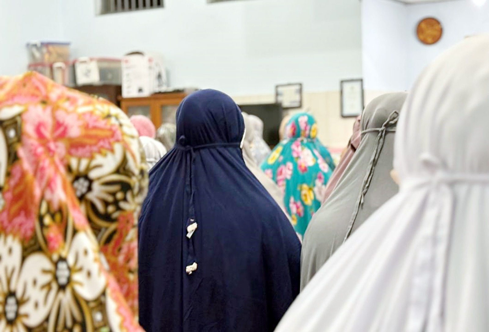 BERKAH RAMADAN: Warga binaan Lapas Perempuan Kelas IIA Malang menjalani salat tarawih secara berjamaah kemarin malam. Foto kanan, Ana Yuniarti berjalan di lorong Lapas Perempuan Kelas IIA Malang