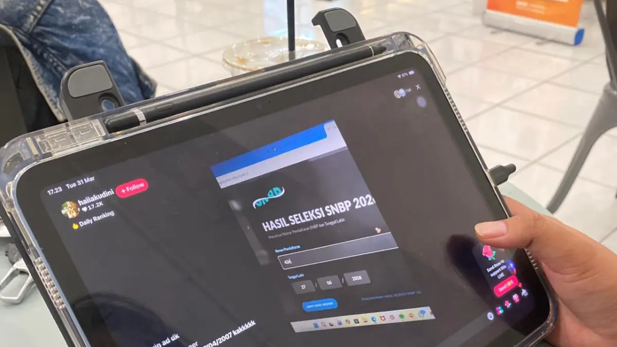 Seorang peserta menonton live TikTok yang dilakukan joki cek pengumuman SNBP 2026. (Rori Dinanda Bestari/Radar Malang)