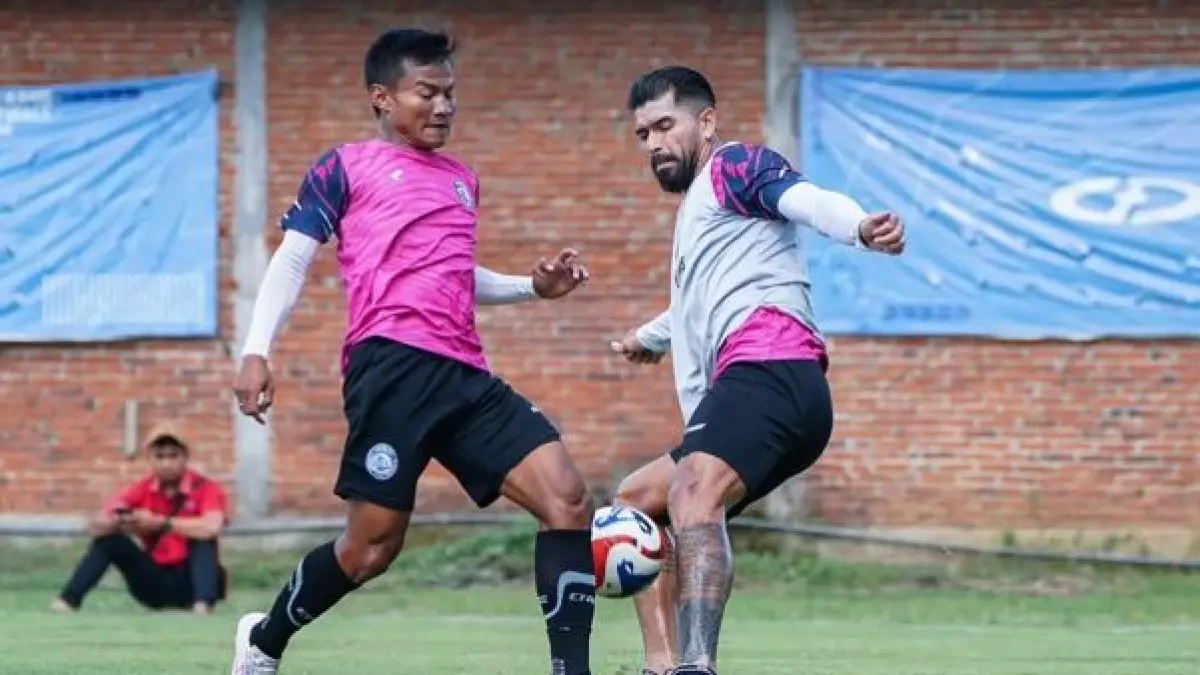 INGIN BERTAHAN SOLID: Julian Guevara dan Bayu Setiawan berebut bola dalam sesi internal game Arema FC di Dreams Football Pitch, Pakis.  (foto: MO Arema FC)