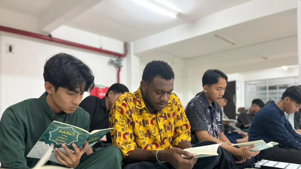 Rocky Marcelino George Wonda, mahasiswa nonmuslim UIN Maulana Malik Ibrahim Malang asal Kabupaten Nabire, Papua Tengah, yang tinggal di mahad sedang mengikuti kajian bersama rekannya, Selasa (7/4) lalu. (Zanadia Manik Fatimah/Radar Malang)