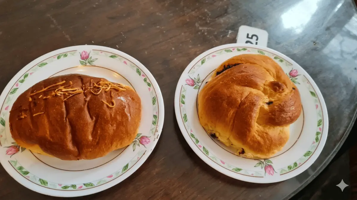Dua buah roti empuk berwarna cokelat keemasan dengan varian topping keju dan isian cokelat. (Alfans / Google Maps)