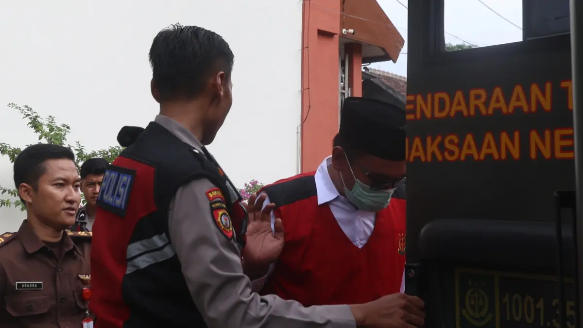 Eks Polisi Agus Saleman (kanan) setelah menjalani sidang perdana di PN Malang pada 20 Mei lalu. (Darmono/Radar Malang)