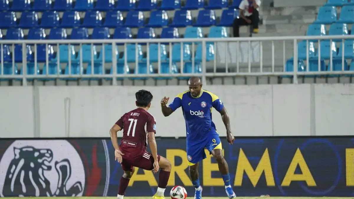 Striker Arema FC Joel Vinicius berduel dengan pemain belakang PSM Makassar di Stadion Kanjuruhan. (MO Arema FC)