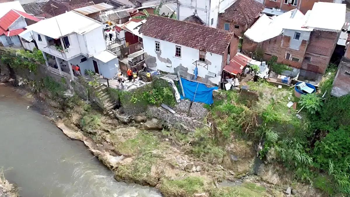 BUTUH PERHATIAN: Salah satu plengsengan yang rusak di Jalan Brigjen Slamet Riyadi, Klojen ditutup dengan terpal berwarna biru. (Kecamatan Klojen For Radar Malang)