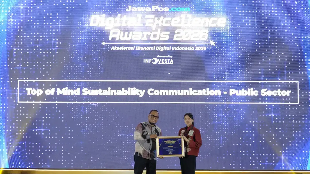 CEO JawaPos.com Dhimas Ginanjar menyerahkan penghargaan Top Sustainability Communication by Energy & Infrastructure dalam ajang Jawa Pos Digital Excellence Award 2026. kepada Sr. Officer Media Communication PT Pertamina (Persero), Intania Prionggo di Hotel Bidakara, Jakarta Selatan, Kamis (30/7). (Istimewa/Jawapos.com)